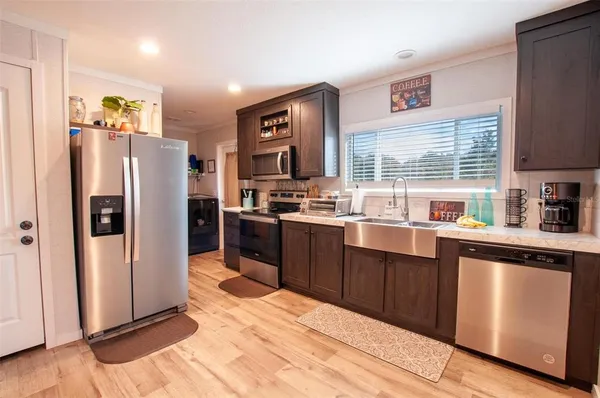a kitchen with stainless steel appliances granite countertop a refrigerator and a sink