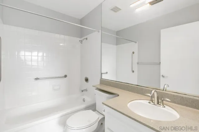 a bathroom with a sink toilet tub and shower
