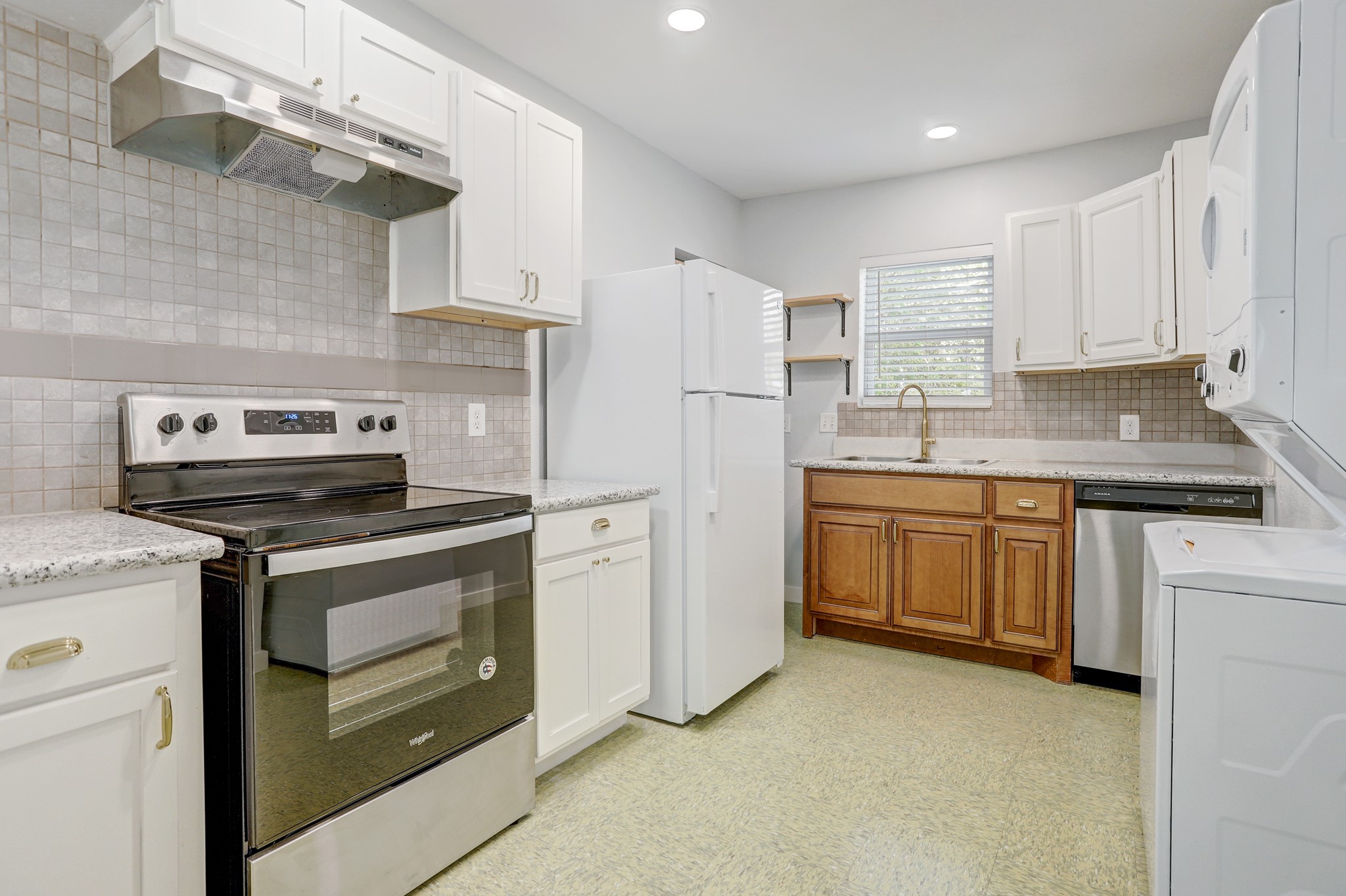 a kitchen with a stove sink and refrigerator