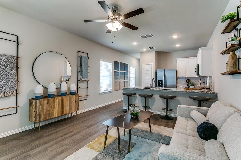 5401 Barlean Ranch, Unit 33L Fort Worth, TX 76123 - Photo 9 of 18 a living room with kitchen furniture and a wooden floor