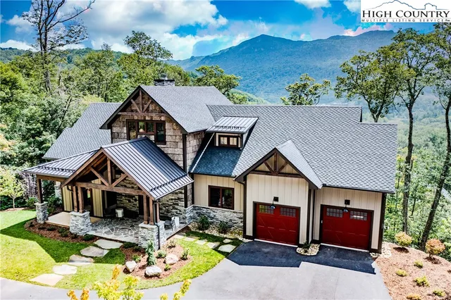 a aerial view of a house with swimming pool and a yard