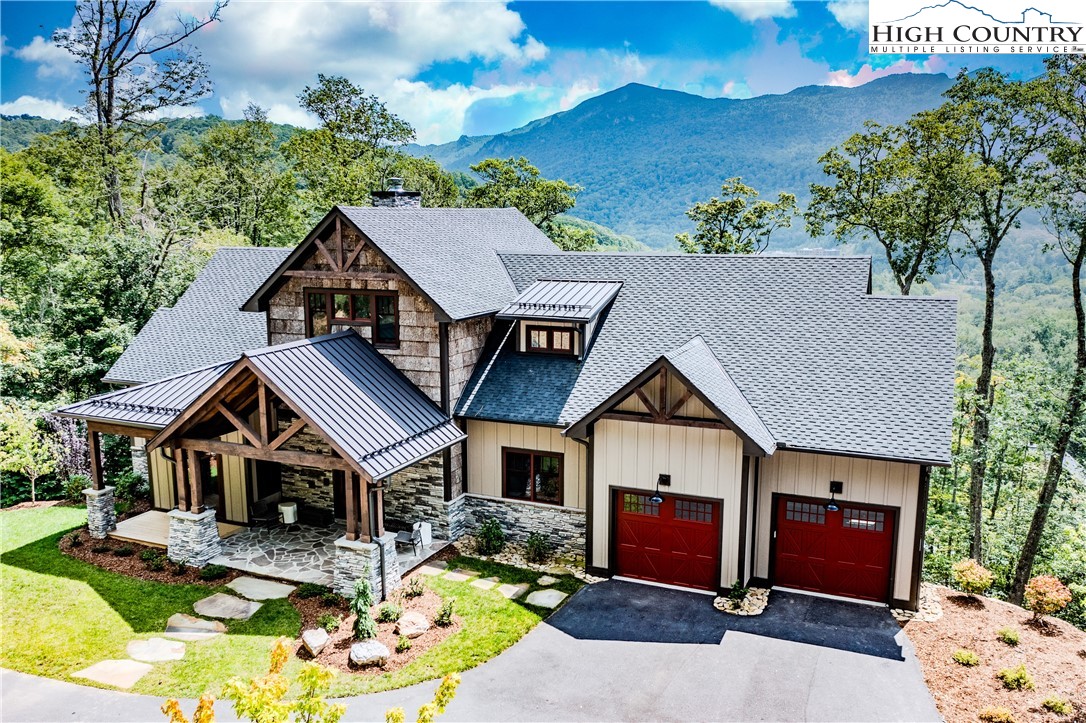 a aerial view of a house with swimming pool and a yard
