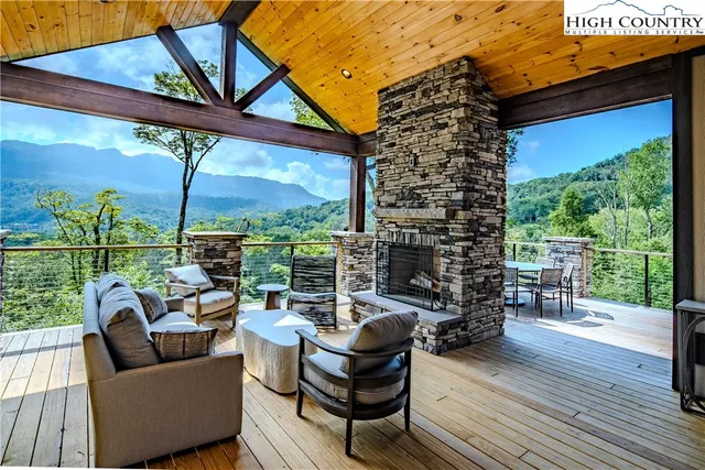 a living room with patio furniture and a floor to ceiling window