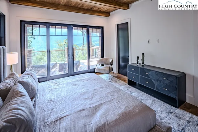 a spacious bedroom with a bed and large windows