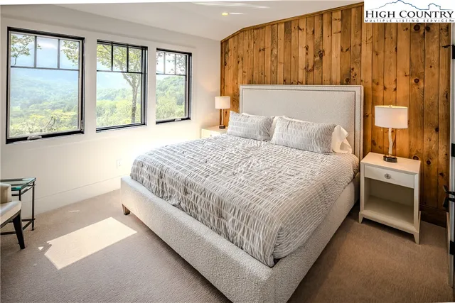 a bedroom with a large bed and a window