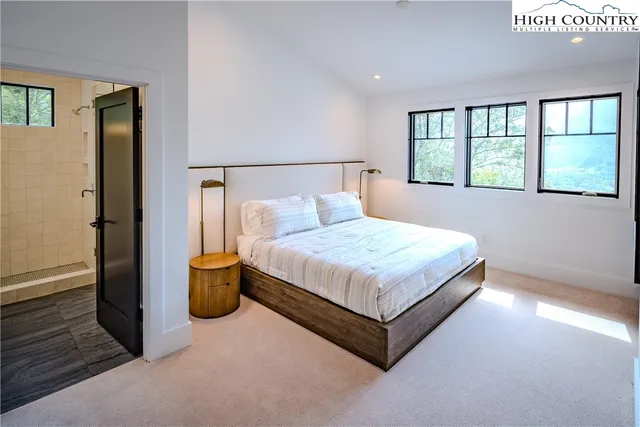 a bedroom with a large bed and a window