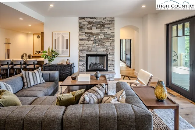 a living room with furniture fireplace and a large window