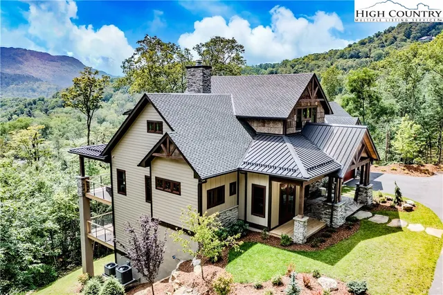 a aerial view of a house with a yard table and chairs