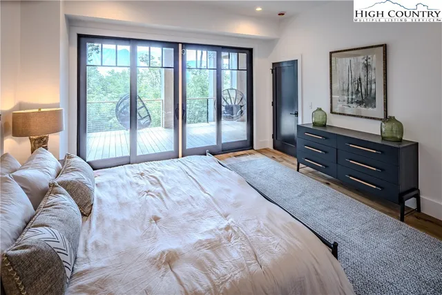 a bedroom with a bed dresser and window