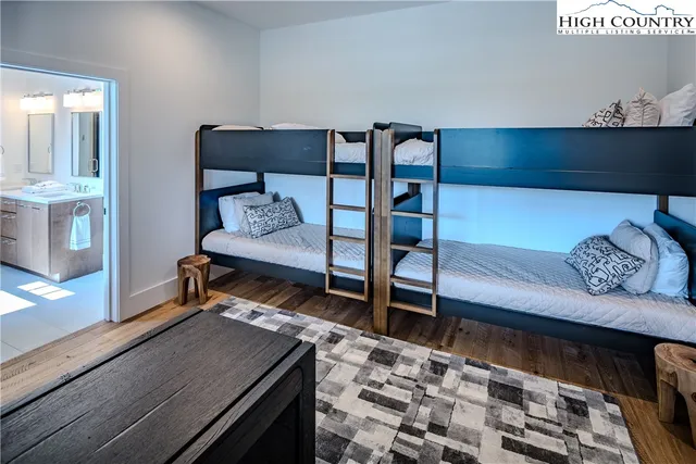 a bedroom with furniture and a rug