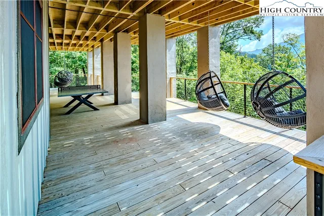 a view of a porch with wooden floor and outdoor space