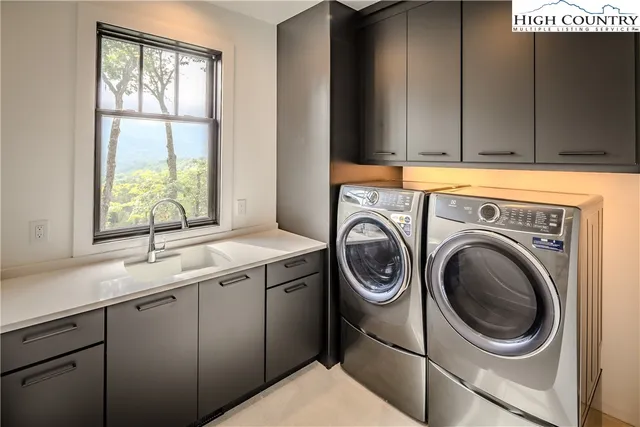 a utility room with a sink dryer and washer