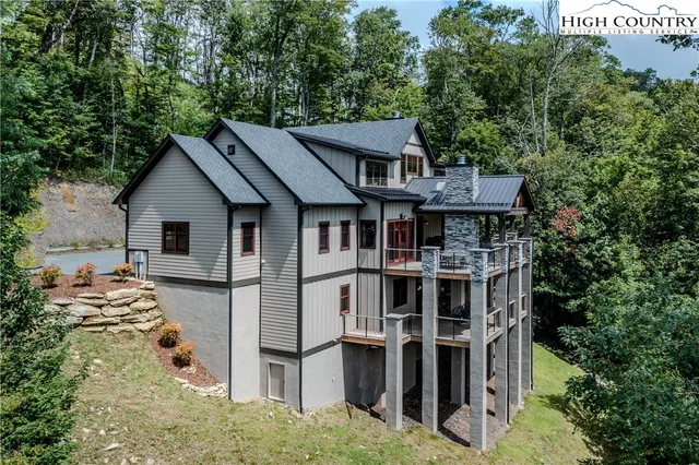 a front view of a house with a yard and potted plants