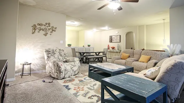 a living room with furniture and white walls
