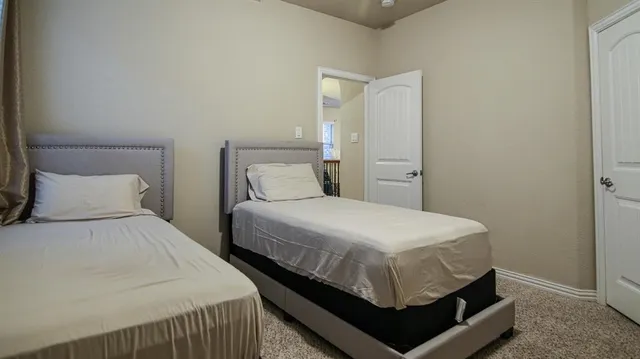 a bedroom with a bed and a night stand