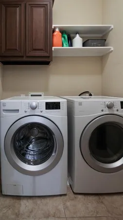 a utility room with sink dryer and washer