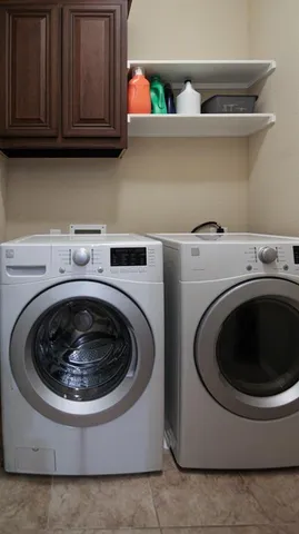 a utility room with sink dryer and washer