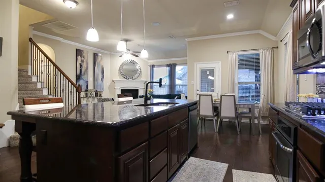 a kitchen with counter top space a sink appliances and cabinets