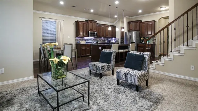 a living room with furniture and kitchen view
