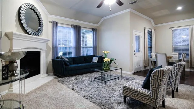 a living room with furniture a fireplace and a flat screen tv