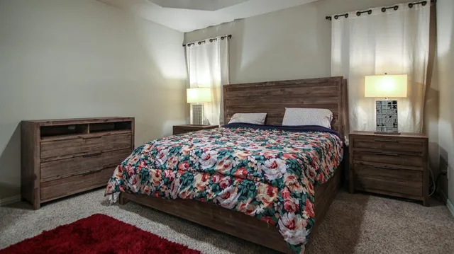 a bedroom with a bed and a mirror