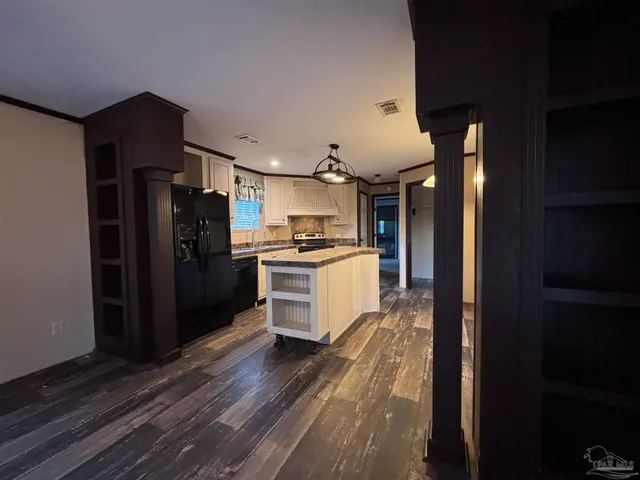 a kitchen with granite countertop stainless steel appliances and refrigerator