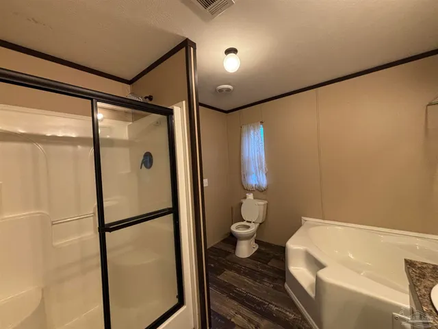 a bathroom with a toilet and a shower