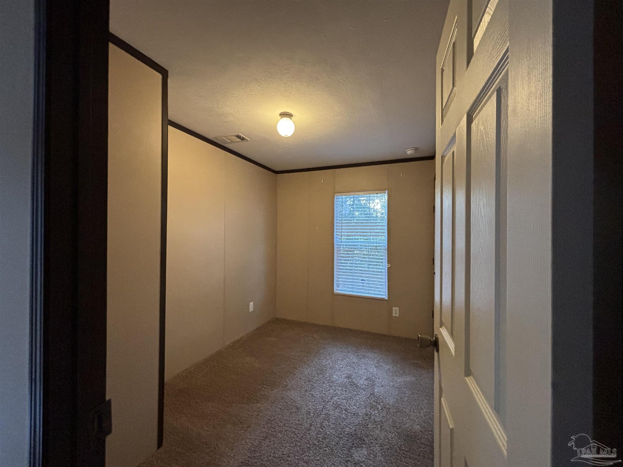 6261 Morgan Road Milton, FL 32570 - Photo 6 of 8 a view of an empty room and window