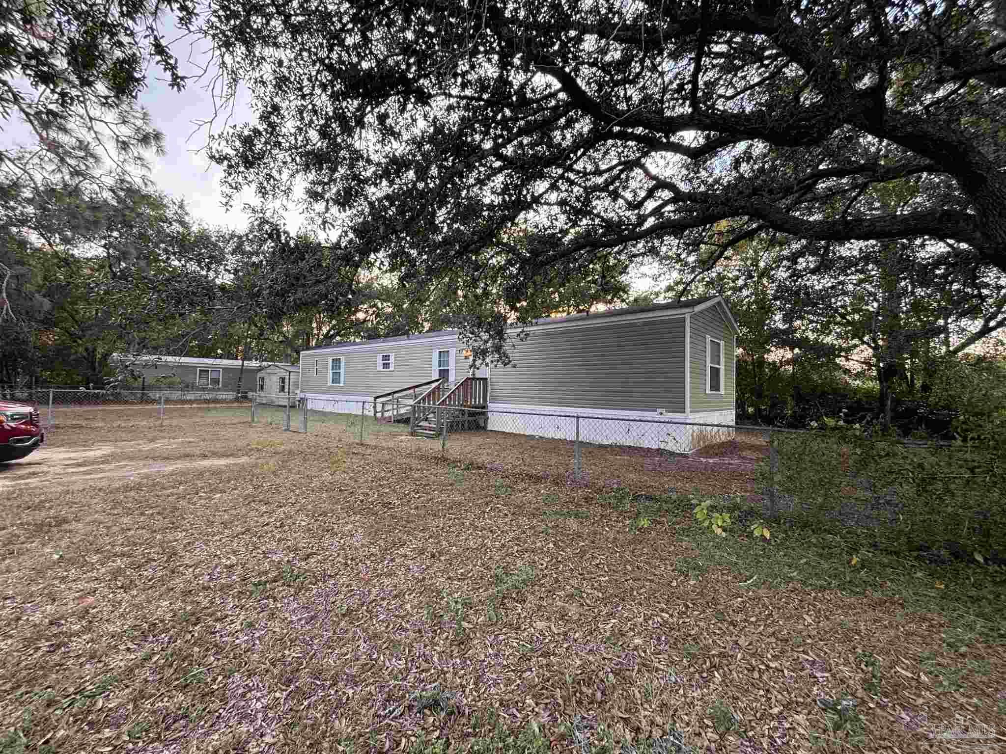 6261 Morgan Road Milton, FL 32570 - Photo 8 of 8 a view of a house with a yard and tree s