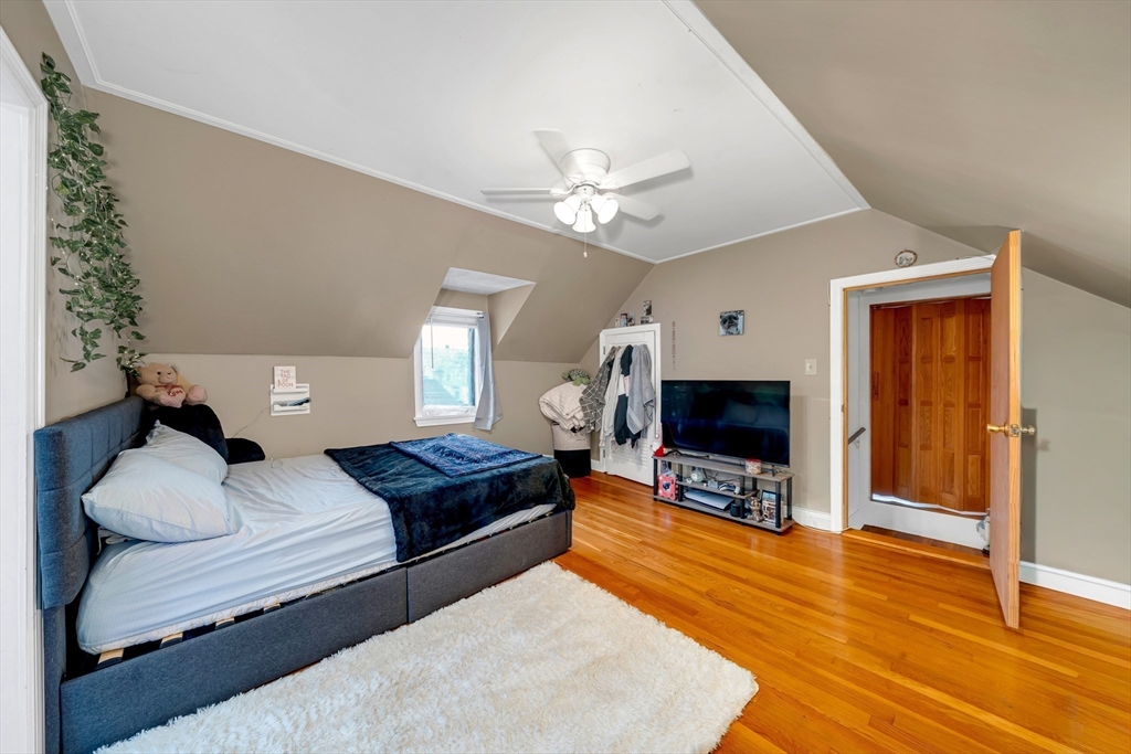 73 Waterhill Street Lynn, MA 01905 - Photo 11 of 33 a bedroom with furniture and a flat screen tv