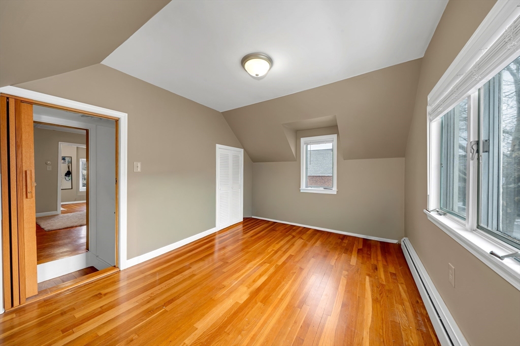 73 Waterhill Street Lynn, MA 01905 - Photo 14 of 33 wooden floor in an empty room with a window