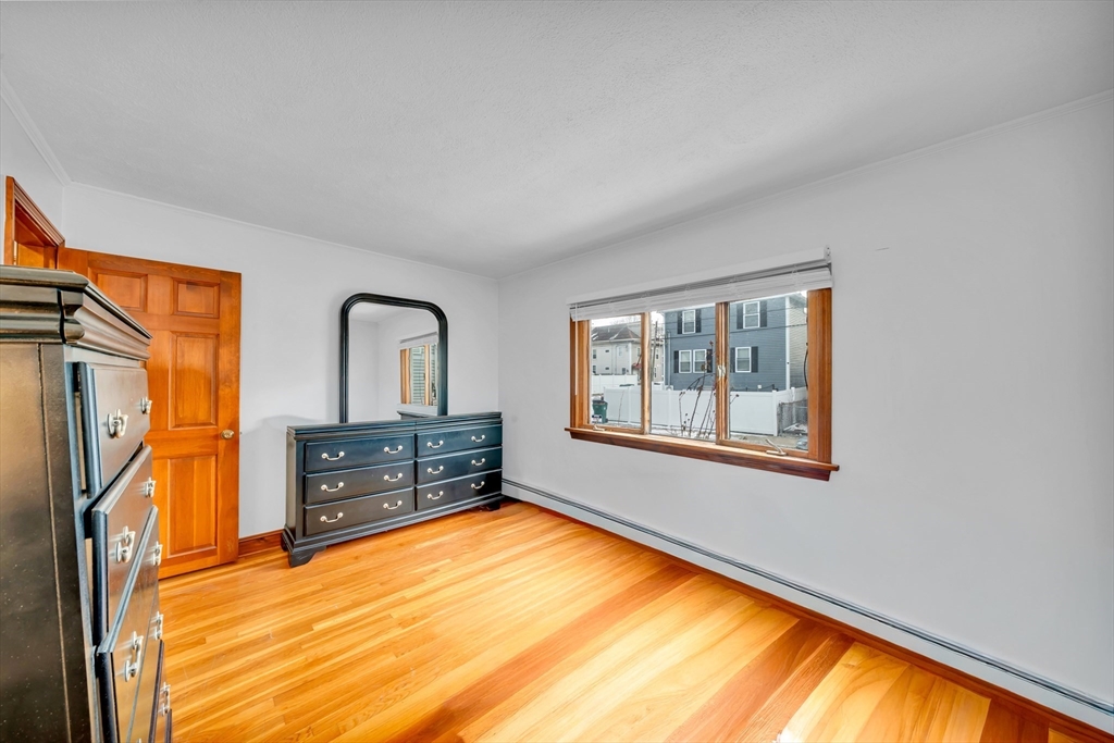 73 Waterhill Street Lynn, MA 01905 - Photo 16 of 33 a view of empty room with wooden floor and fan