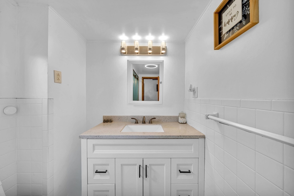 73 Waterhill Street Lynn, MA 01905 - Photo 18 of 33 a bathroom with a sink and a mirror