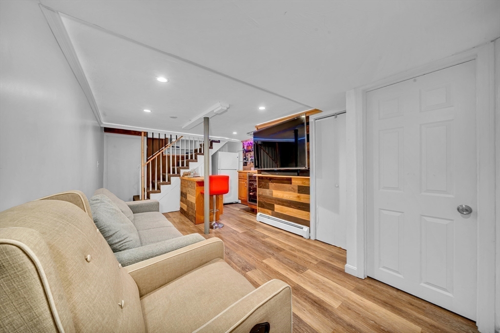 73 Waterhill Street Lynn, MA 01905 - Photo 21 of 33 a living room with furniture and a flat screen tv