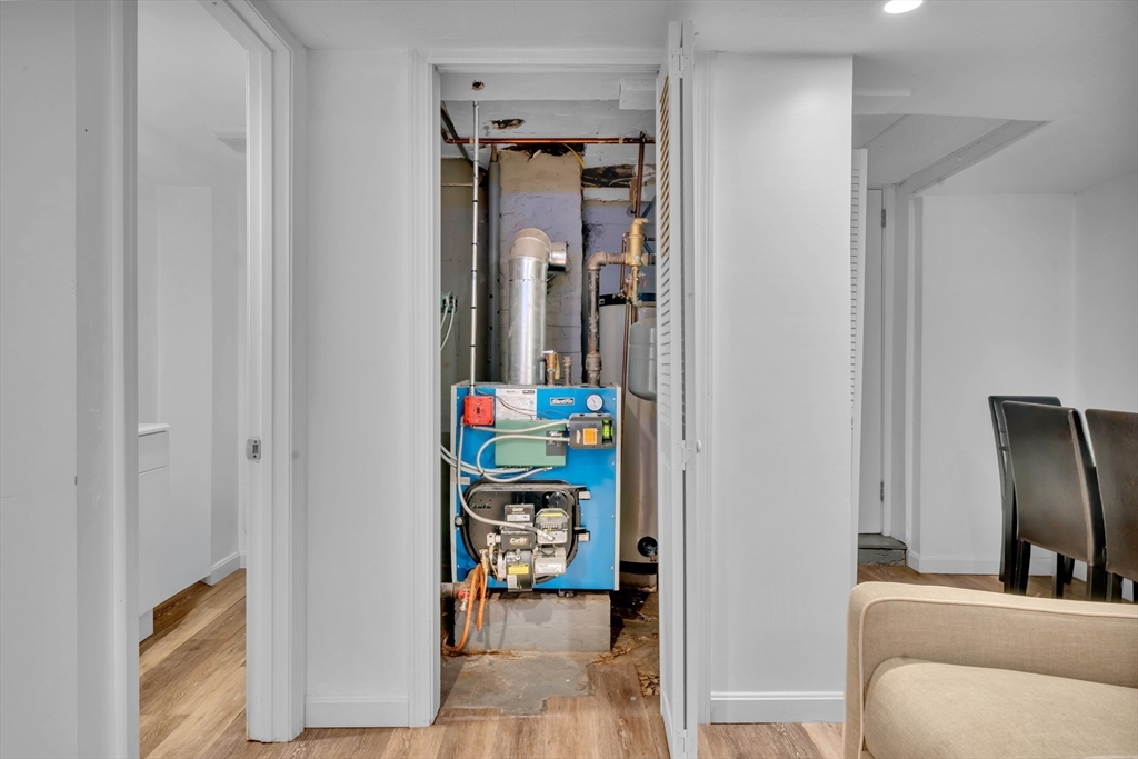 73 Waterhill Street Lynn, MA 01905 - Photo 25 of 33 a living room with furniture and a walk in closet with wooden floor