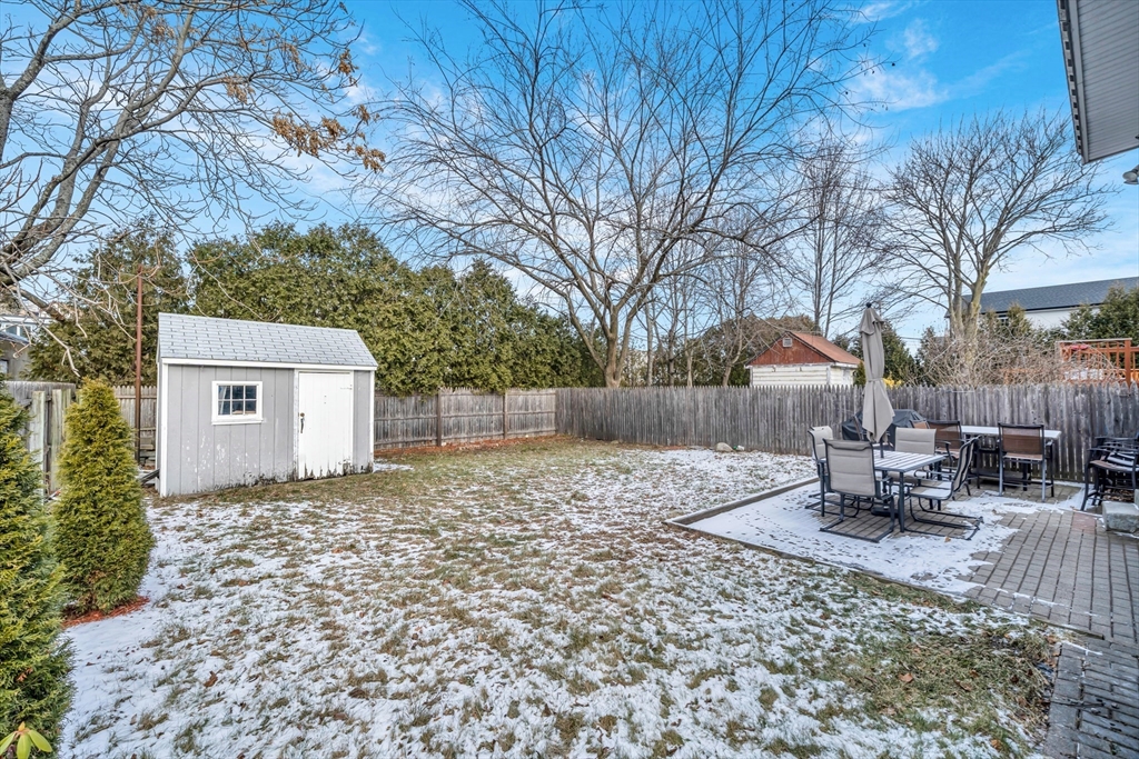 73 Waterhill Street Lynn, MA 01905 - Photo 27 of 33 a backyard of a house with table and chairs