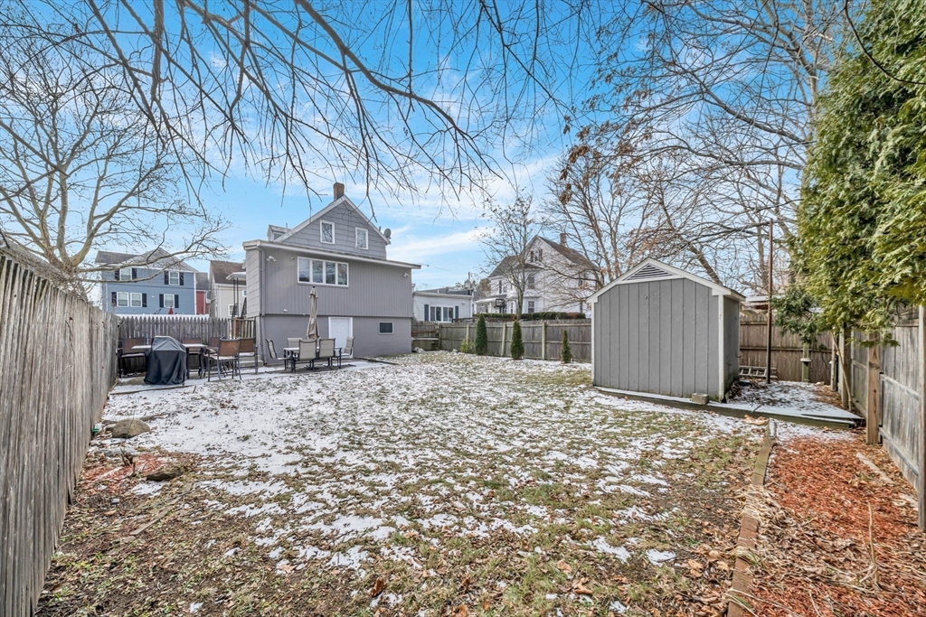 73 Waterhill Street Lynn, MA 01905 - Photo 29 of 33 a front view of a house with a yard covered in snow