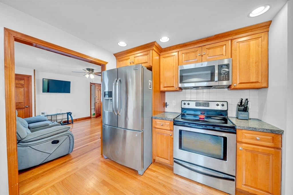 73 Waterhill Street Lynn, MA 01905 - Photo 4 of 33 a kitchen with appliances a sink and cabinets