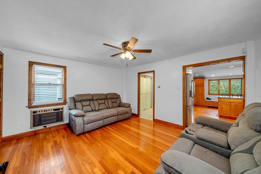 73 Waterhill Street Lynn, MA 01905 - Photo 8 of 33 a living room with furniture and a large window