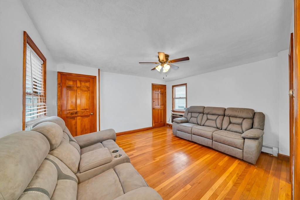 73 Waterhill Street Lynn, MA 01905 - Photo 9 of 33 a living room with furniture and a large window