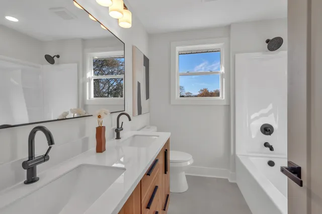a bathroom with a toilet sink and shower
