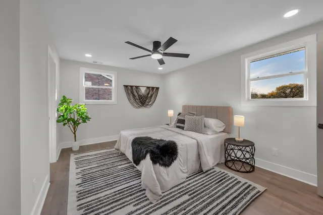 a bedroom with a bed and a chandelier