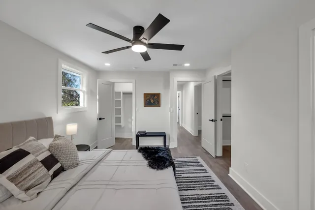 a bedroom with a large bed and a chandelier