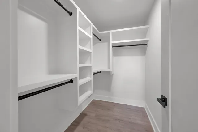 a view of walk in closet with empty racks