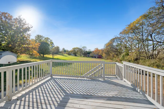a view of a balcony with wooden floor