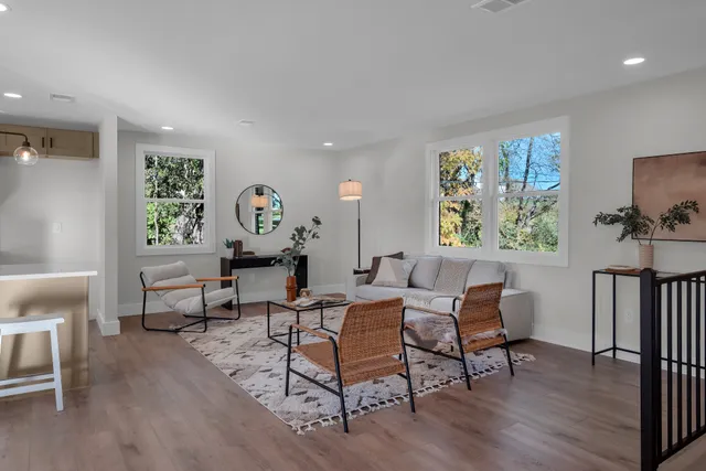 a living room with furniture and a wooden floor