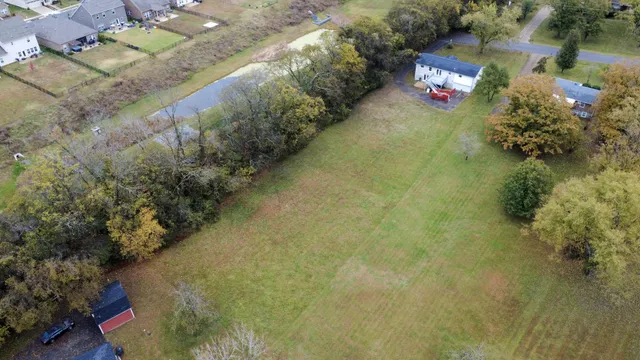 a view of a house with pool and yard