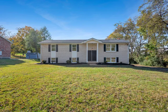 a front view of house with yard and trees
