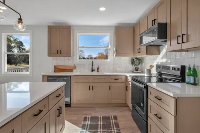 a kitchen with a sink stove and microwave