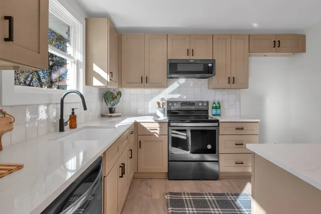 a kitchen with a sink stove and cabinets